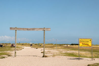 Information sign on field against clear sky