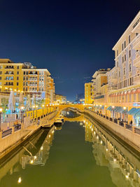 Illuminated buildings in city at night