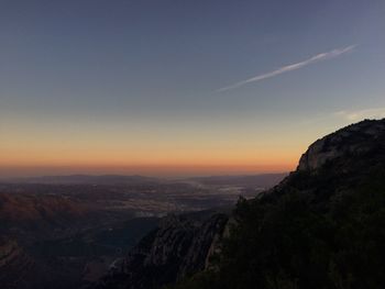 Scenic view of montserrat and landscape against sky during sunset