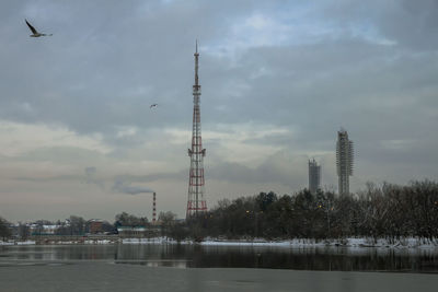 River by buildings against sky