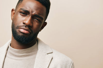 Portrait of young man against gray background