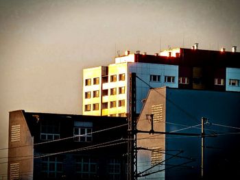 Buildings in city against sky at dusk