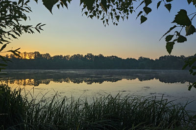 Scenic view of lake against sky during sunset