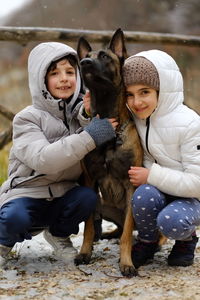 Portrait of kids with dog belgian malinois