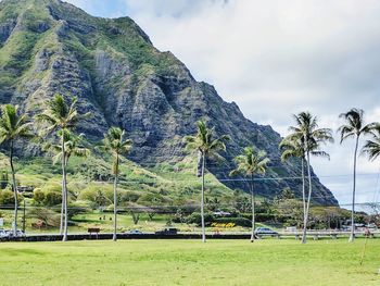 Scenic view of green mountains against sky