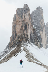 Full length of man on snow covered mountain against sky