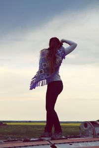 Rear view of woman standing on field