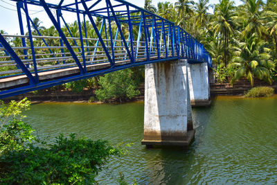 Bridge over river against trees