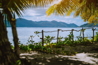 Scenic view of sea and mountains against sky