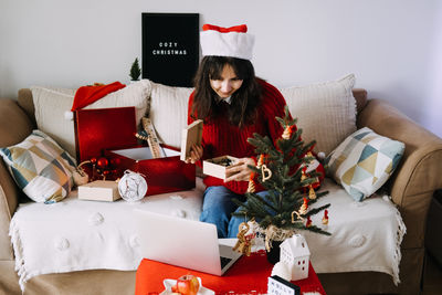 Portrait of woman using laptop at home