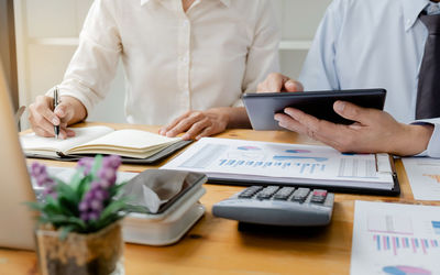 Midsection of man using laptop on table