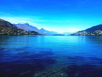 Scenic view of lake against blue sky