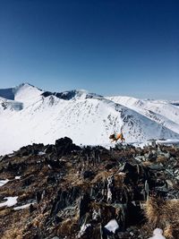 Aerial view of snowcapped mountains against clear sky