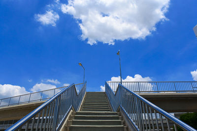 Low angle view of footbridge against blue sky