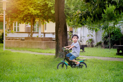 Portrait of smiling girl riding bicycle on field