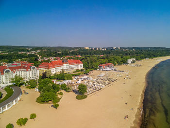 High angle view of buildings against clear blue sky