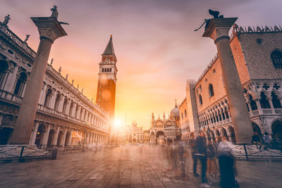 Buildings in city at sunset