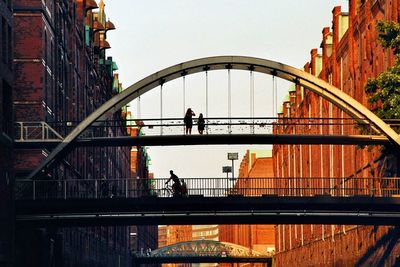 People walking on footbridge