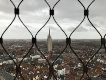 Cityscape seen through chainlink fence