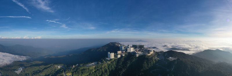 Panoramic shot of building and mountains against sky