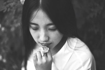 Close-up of young woman with flower