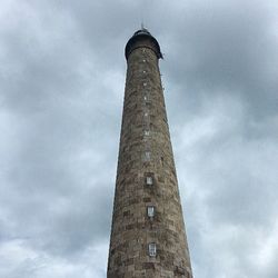 Low angle view of tower against cloudy sky