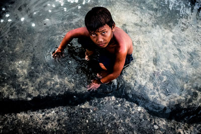 Portrait of young woman in water