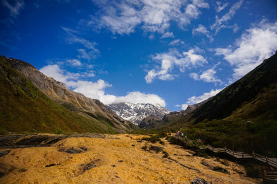 Scenic view of mountains against blue sky