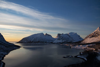 Scenic view of snowcapped mountains against sky during sunset