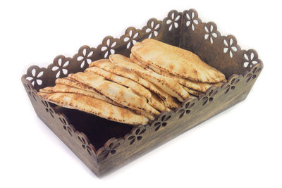 High angle view of bread in plate against white background