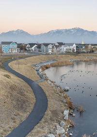 Scenic view of lake by buildings against sky