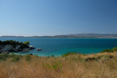 Scenic view of sea against clear blue sky