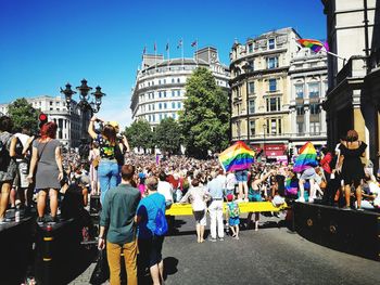 Crowd in city against clear sky