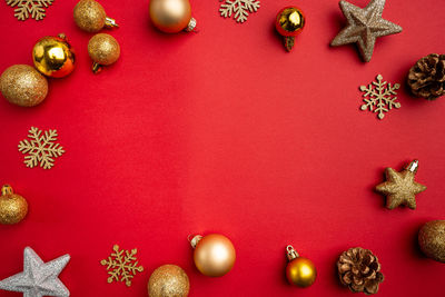 Directly above shot of christmas decorations on yellow background