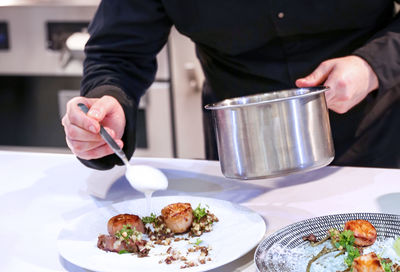 Midsection of man preparing food on table