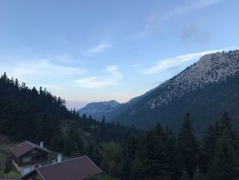 Scenic view of mountain and trees against sky