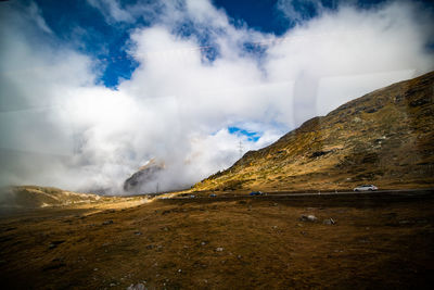 Scenic view of waterfall against sky