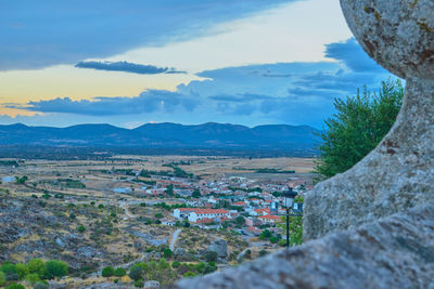 Aerial view of townscape and mountains against sky