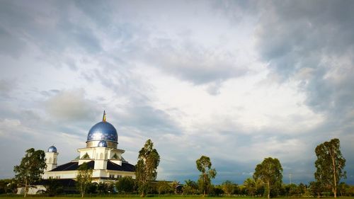 View of church building against cloudy sky