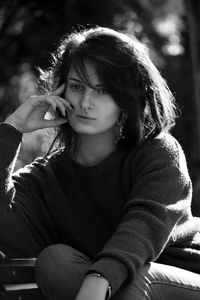 Portrait of a young woman sitting outdoors