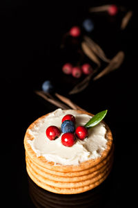 Close-up of strawberry cake against black background