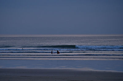 Scenic view of sea against clear sky at dusk