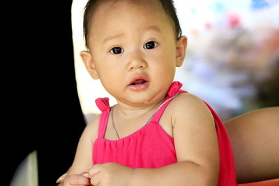 Portrait of cute baby girl drooling outdoors