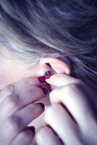 Close-up of woman with hearing aid