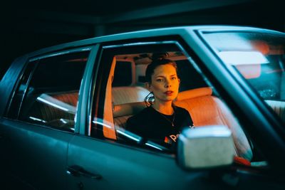 Portrait of woman looking through car window