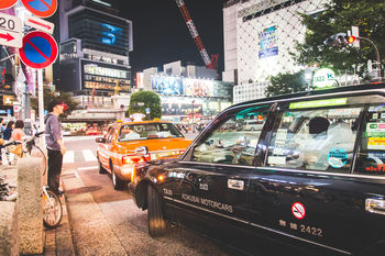 TRAFFIC ON ROAD IN CITY AT NIGHT