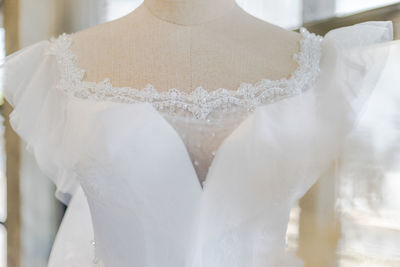 Close-up of woman wearing white dress