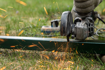 Close-up of machine part on field