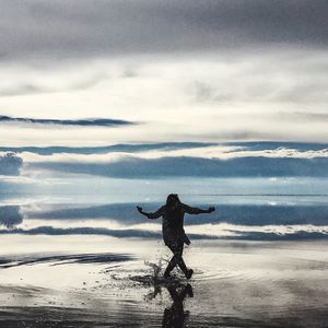 Silhouette of woman standing on beach