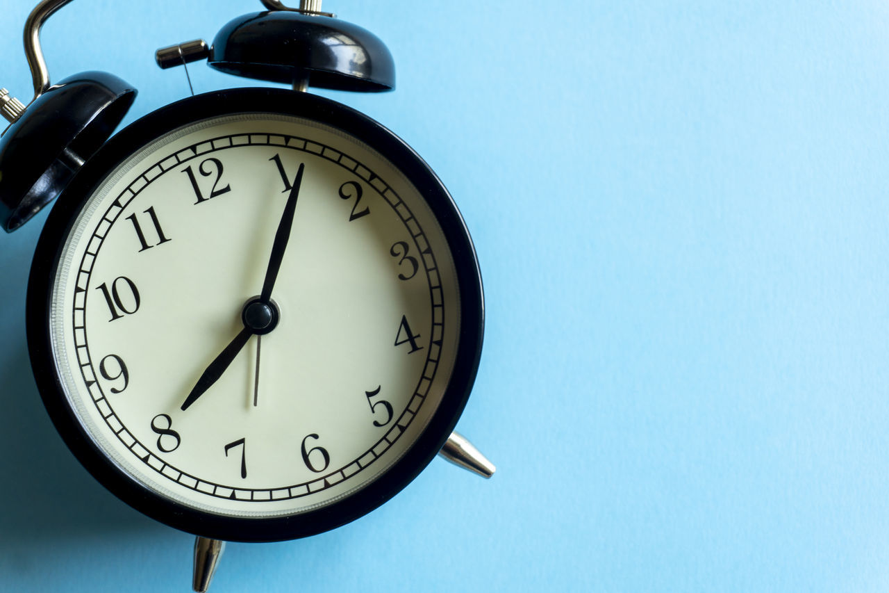 CLOSE-UP OF CLOCK AGAINST WALL